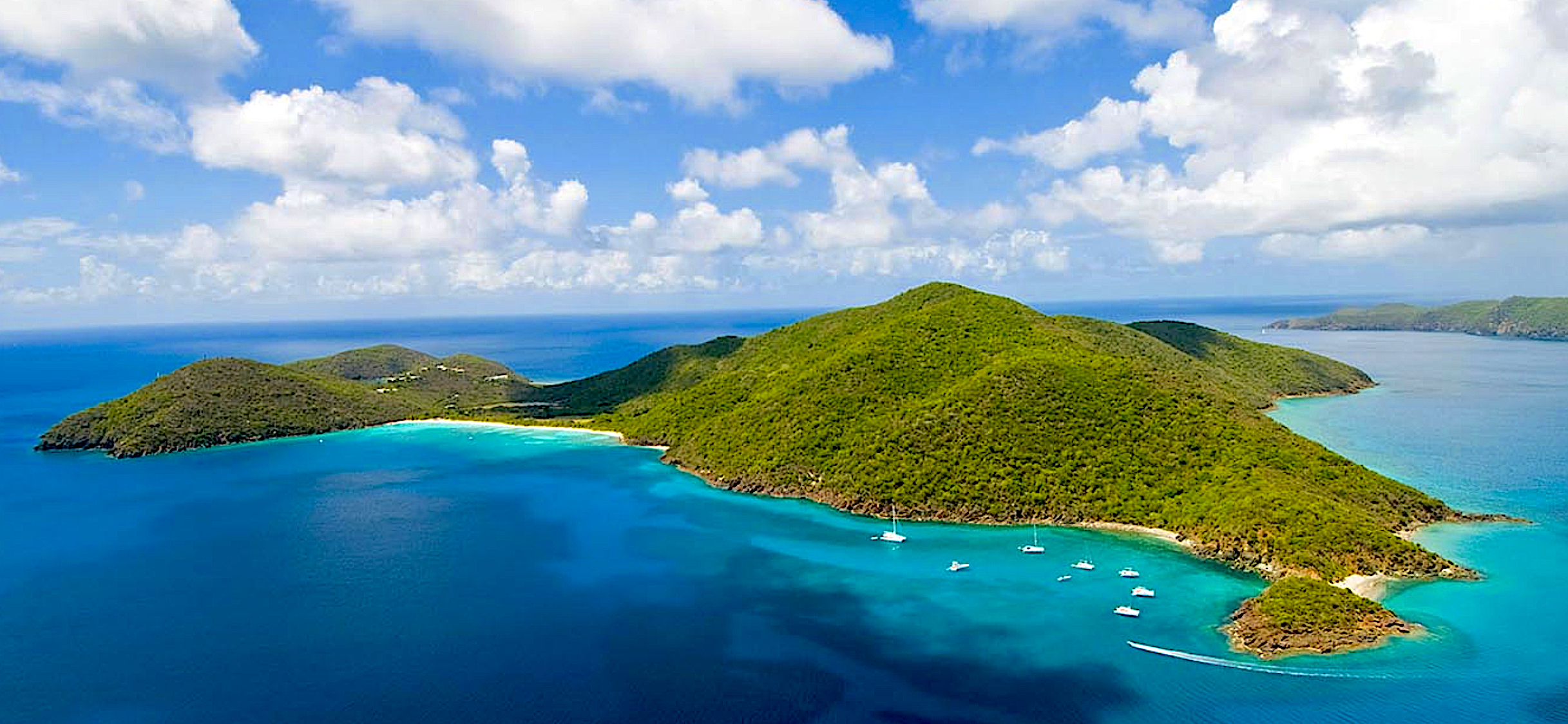Lush green Guana Island surrounded by crystal clear waters in the British Virgin Islands